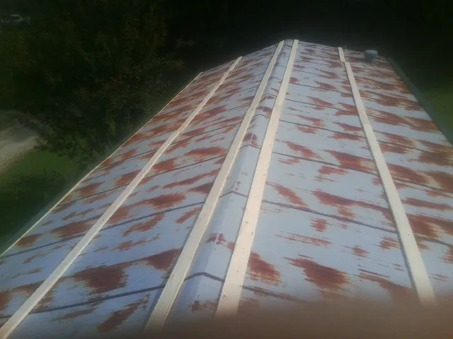 Rusted metal roof panels with new wood purlins before replacement — Storm Damage Roof Repair in Winona by Roofing Brothers