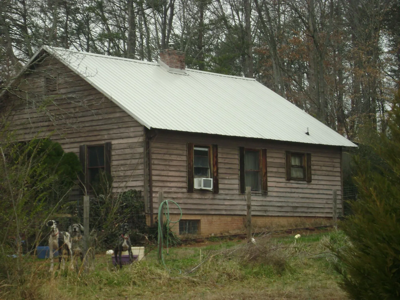 White metal roof on an old wood sided farmhouse, from a Metal Roof Installation job in Winona